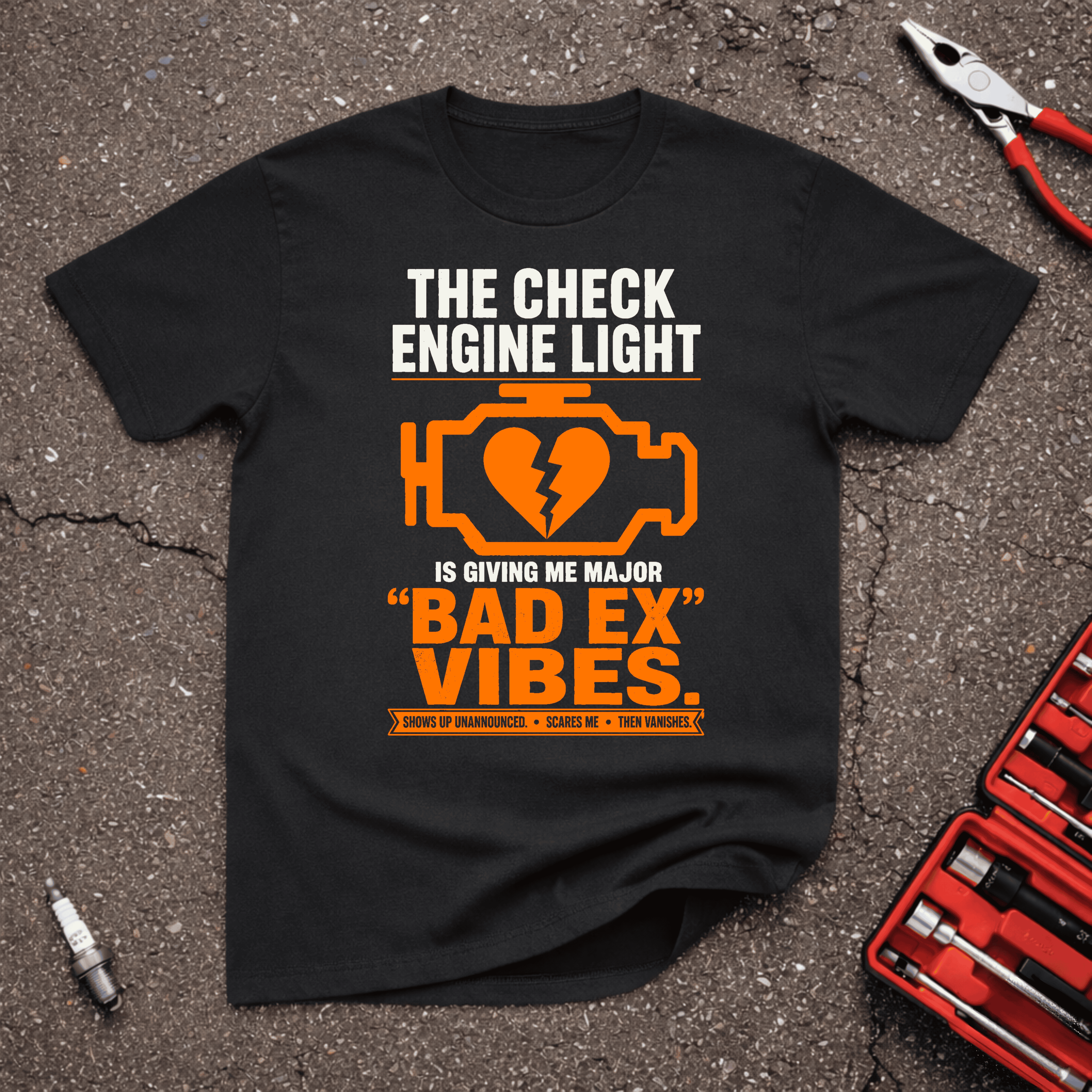 Bad Ex Vibes black funny check engine light t-shirt with orange engine icon, broken heart, and text saying shows up unannounced, scares me, then vanishes — GarageGiggles.com automotive humor apparel.