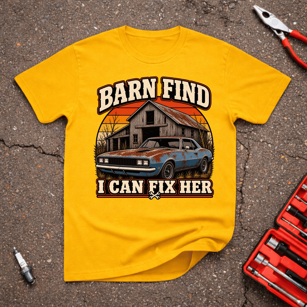 I Can Fix Her funny barn find automotive T-shirt showing rusty blue classic car in front of an old barn with Barn Find I Can Fix Her text on gold shirt.