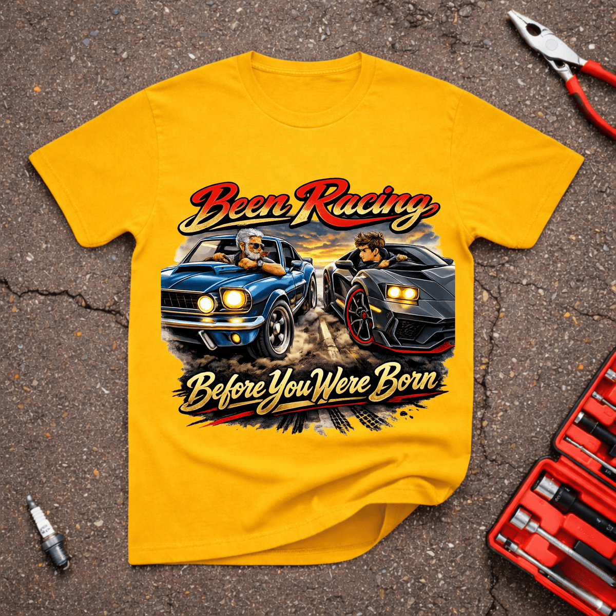 Garage Giggles Racing Before Born T-Shirt featuring an older driver in a classic blue muscle car racing a younger driver in a modern black performance car.