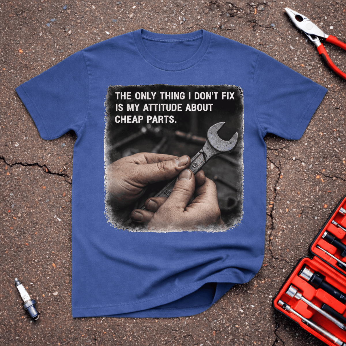 Cheap Parts funny mechanic T-shirt with greasy hands holding wrench and text reading The Only Thing I Don’t Fix Is My Attitude About Cheap Parts on Heather Indigo shirt.
