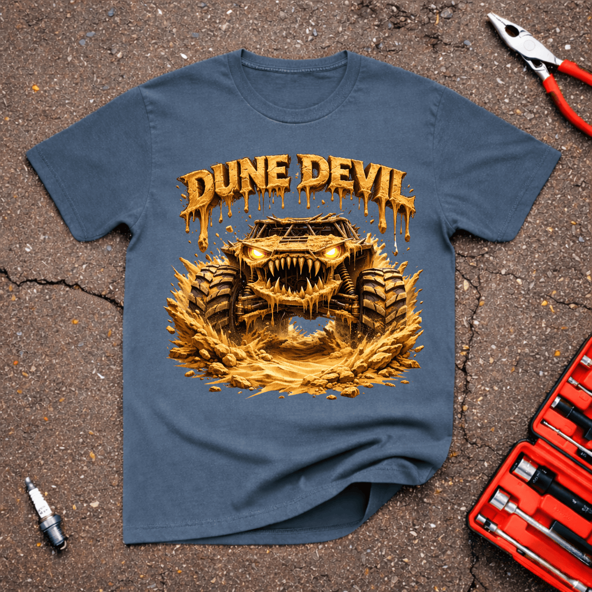 Dune Devil funny off-road T-shirt with aggressive mud-covered dune buggy blasting through sand beneath dripping Dune Devil text on Indigo Blue shirt.