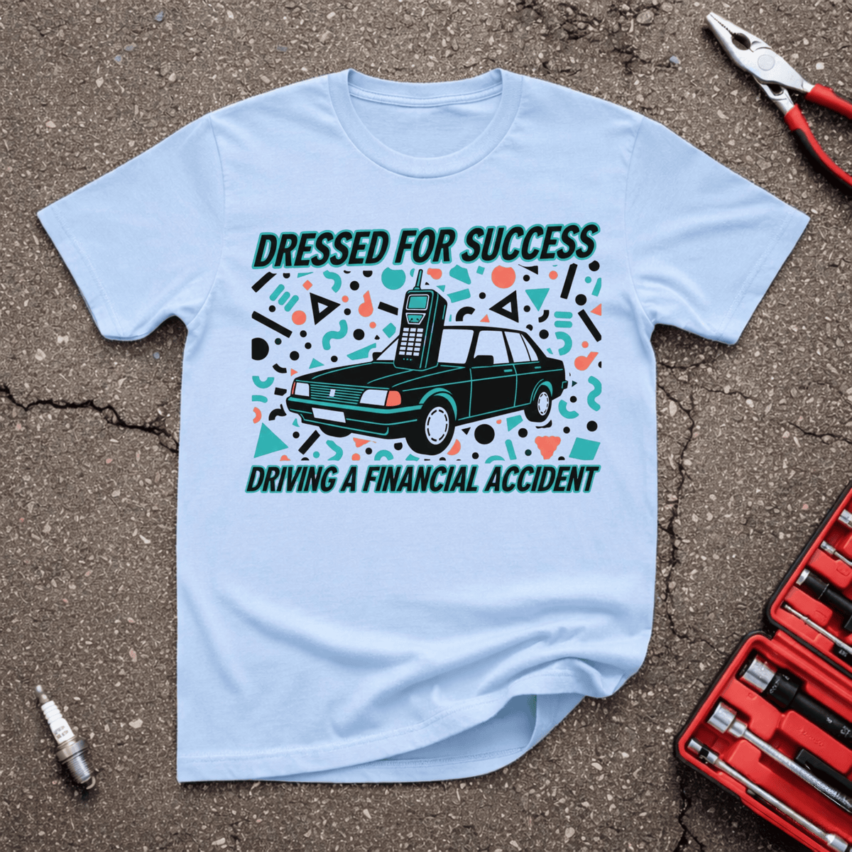 Dressed For Success funny automotive T-shirt with retro car and vintage mobile phone and text Driving A Financial Accident on light blue shirt.