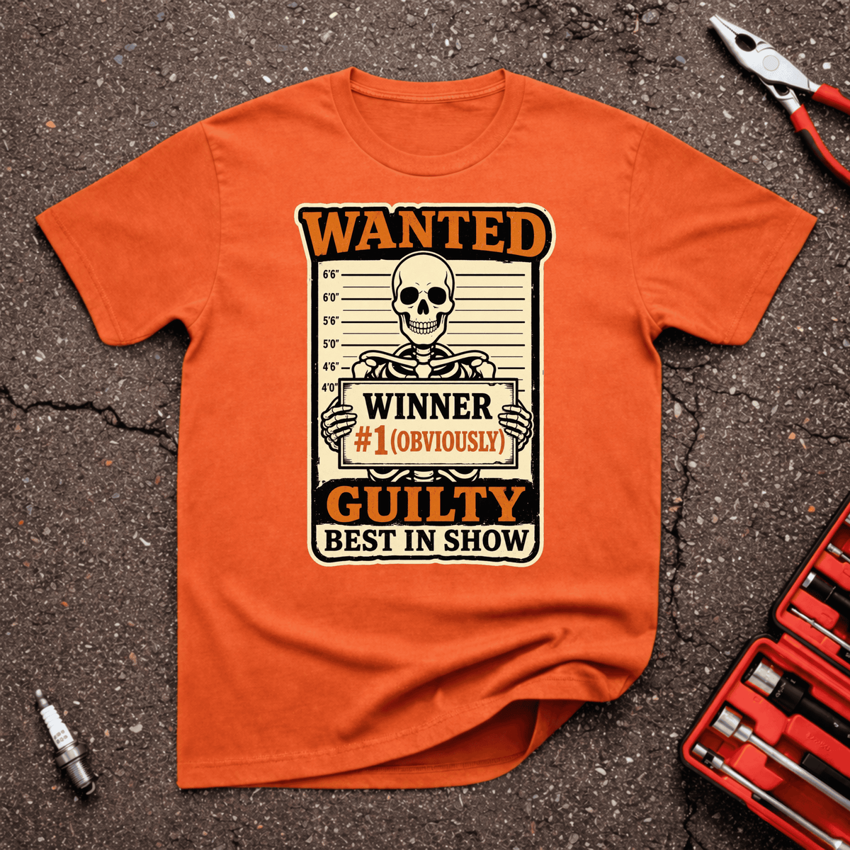 Wanted funny car show T-shirt with skeleton mugshot holding Winner Number One Obviously sign and text reading Guilty Best In Show on orange shirt.