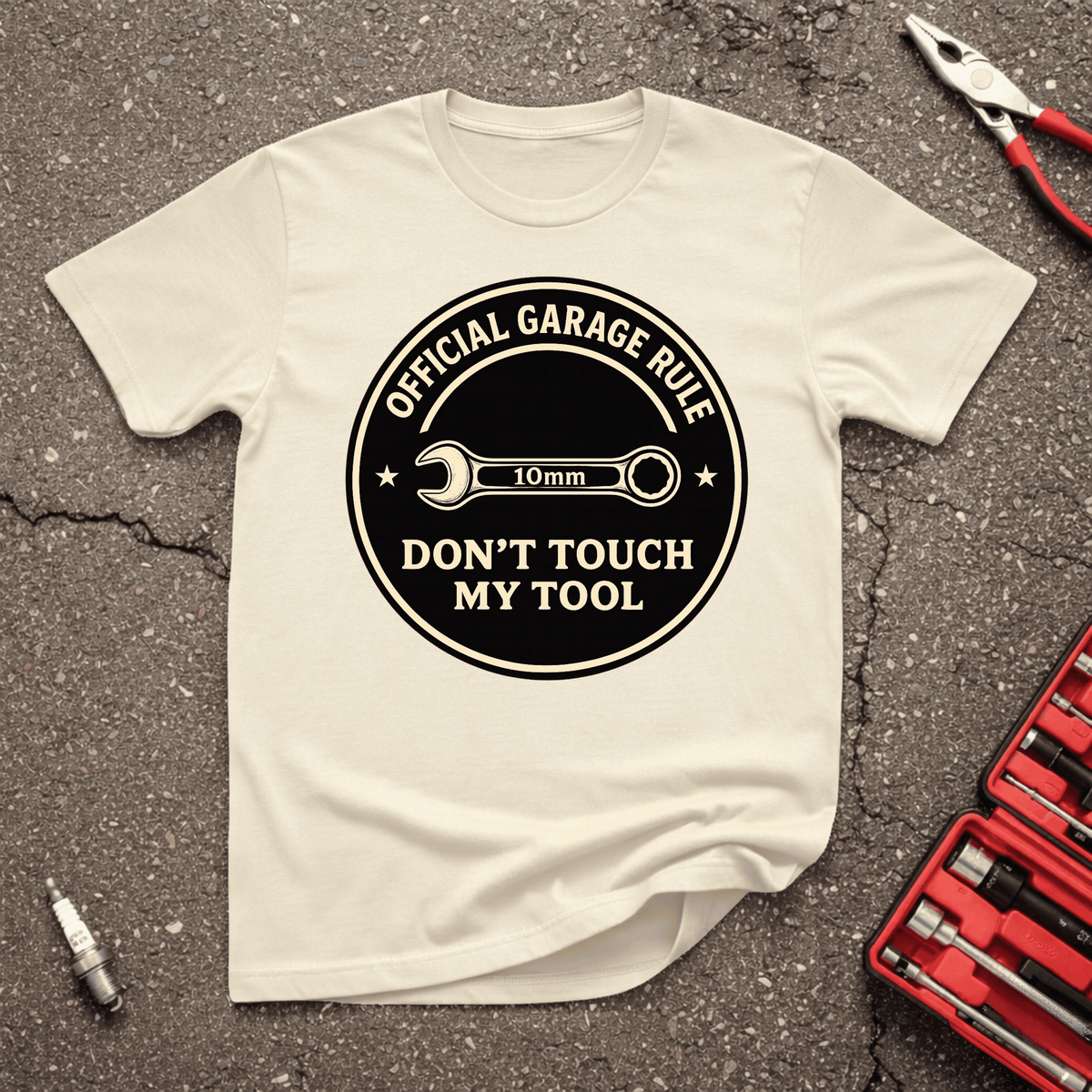 Don’t Touch My Tool funny mechanic T-shirt with official garage rule badge and 10mm wrench on sand-colored shirt.