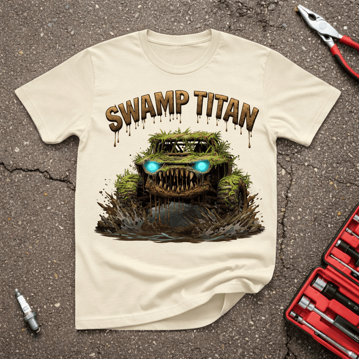 Swamp Titan funny off-road T-shirt with moss-covered monster truck, glowing blue headlights, huge tires, fang-like grille, and dripping Swamp Titan lettering on Sand shirt.