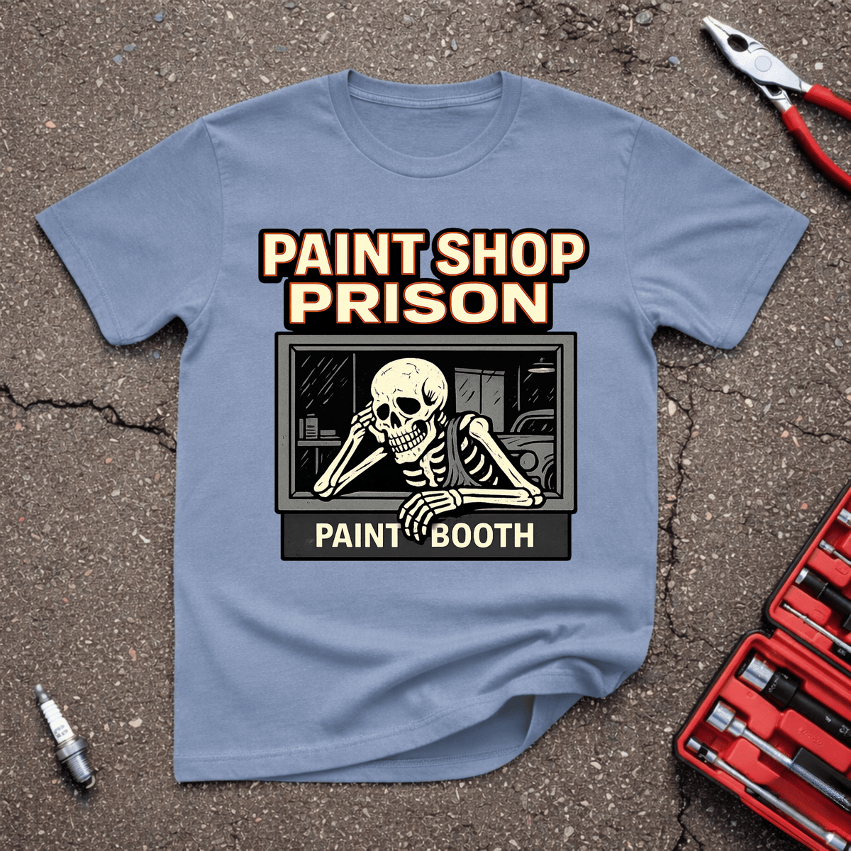 Paint Shop Prison funny project car T-shirt with skeleton waiting inside paint booth window and Paint Shop Prison text on stone blue shirt.
